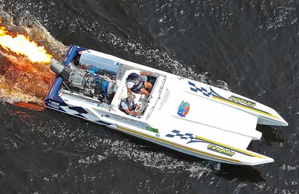 Captain John Hice of Gulf Coast Marine Service and a jet powered flaming turbine engine powers a speed boat during a Panama City Beach, Florida race